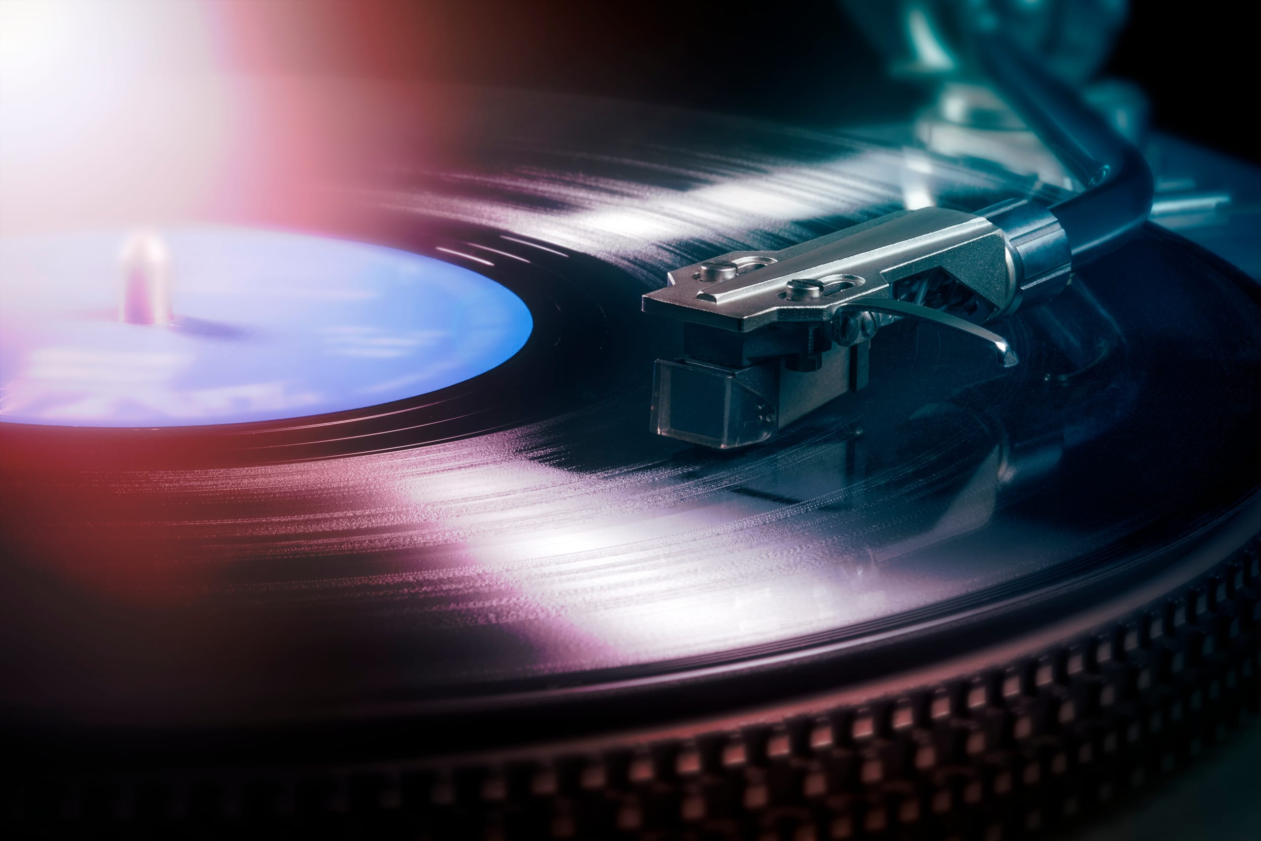 Vinyl record spinning under moody light